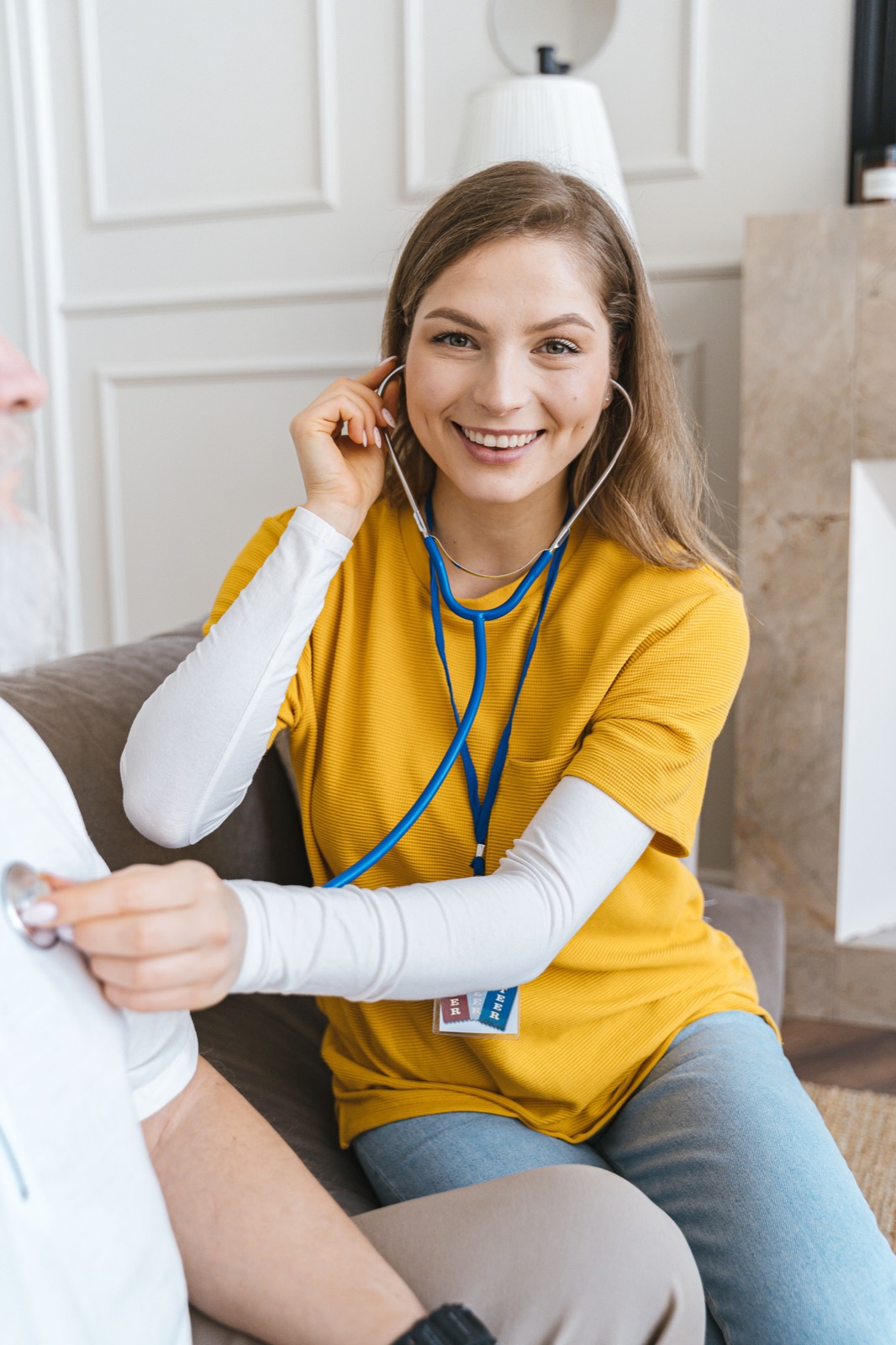 A professional caregiver smiling while supporting a client