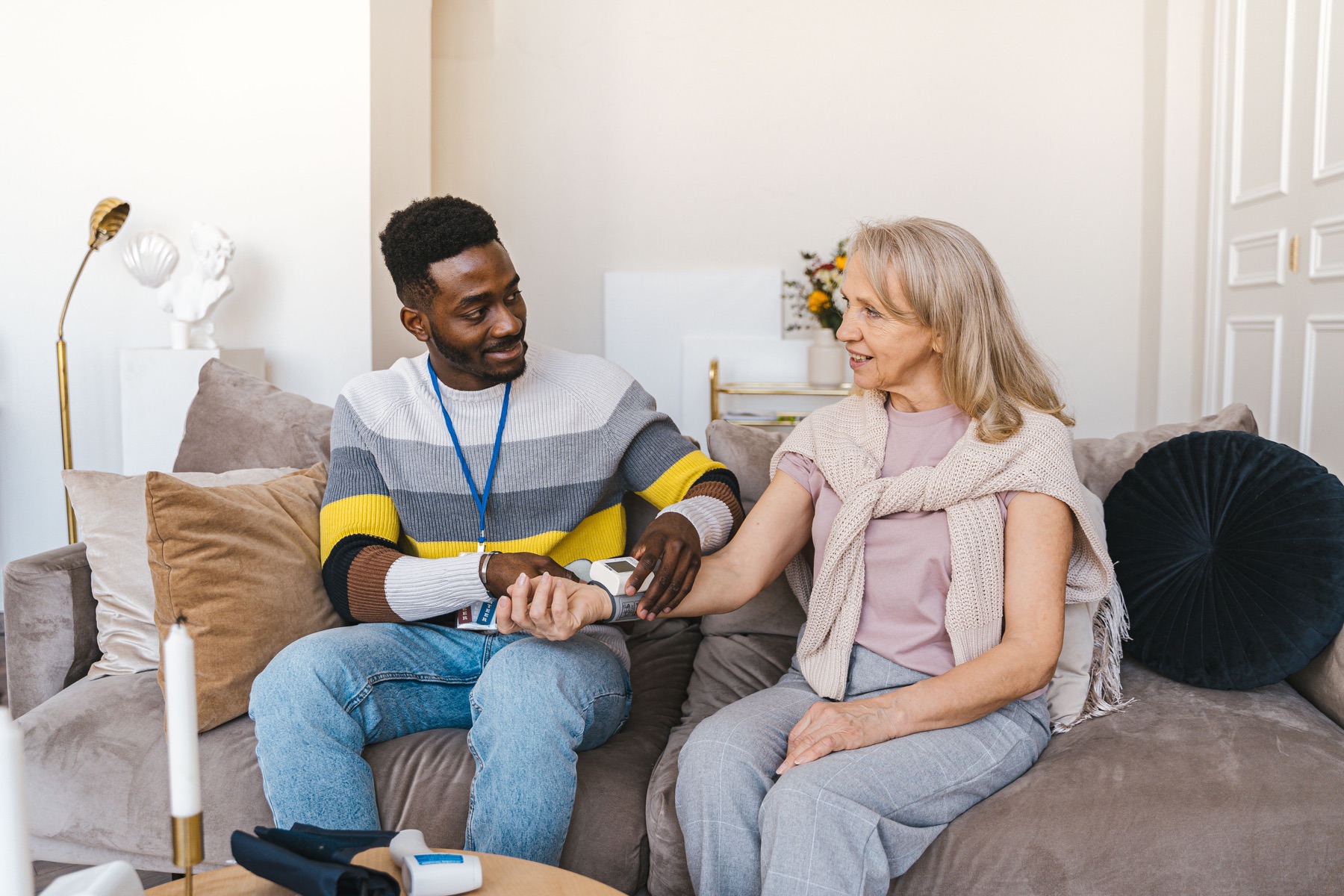 A caregiver sharing a warm moment with an older adult at home